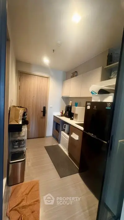 Modern compact kitchen with sleek appliances and wooden cabinetry