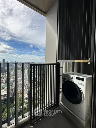 High-rise balcony with stunning city view and modern washing machine.