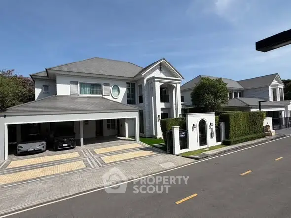 Luxurious modern mansion with spacious driveway and elegant architectural design.