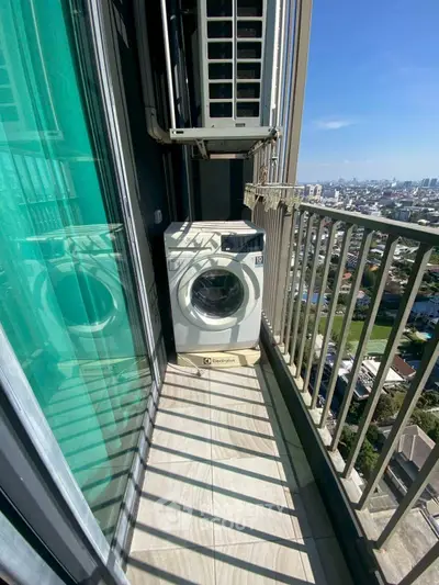 High-rise balcony with washing machine and city view, perfect for urban living convenience.