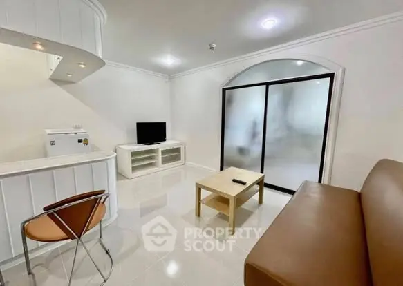 Modern living room with sleek furniture and frosted glass doors, perfect for stylish urban living.