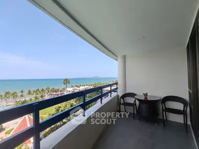 Stunning beachfront balcony with panoramic ocean views and cozy seating area.