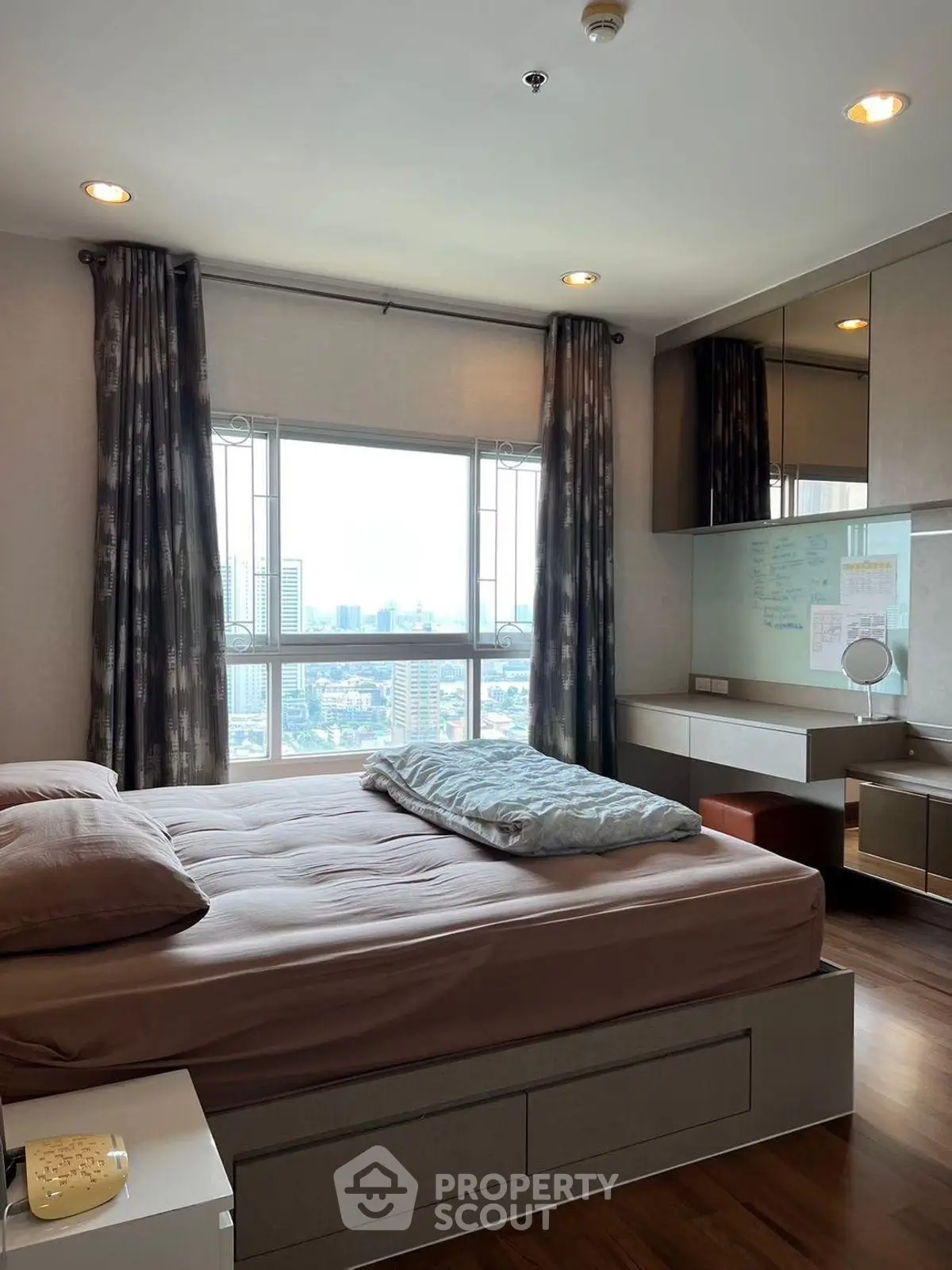 Spacious bedroom with city view and modern furnishings