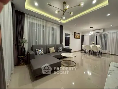 Modern living room with stylish furniture and elegant lighting in a spacious open layout.