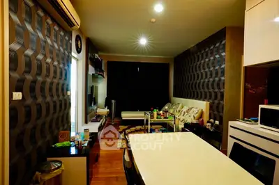 Modern living room with stylish decor and open kitchen layout in a cozy apartment.