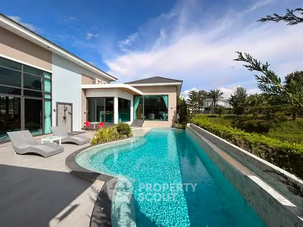 Luxurious modern villa with stunning pool and lush greenery, perfect for serene living.