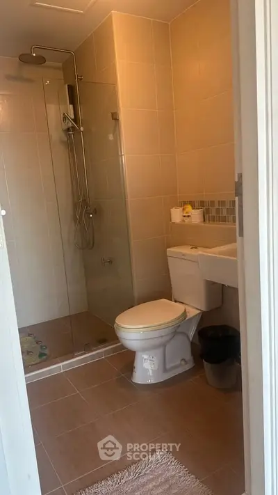 Modern bathroom with shower and toilet in a cozy apartment.