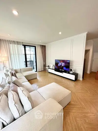 Spacious modern living room with large sofa and entertainment center