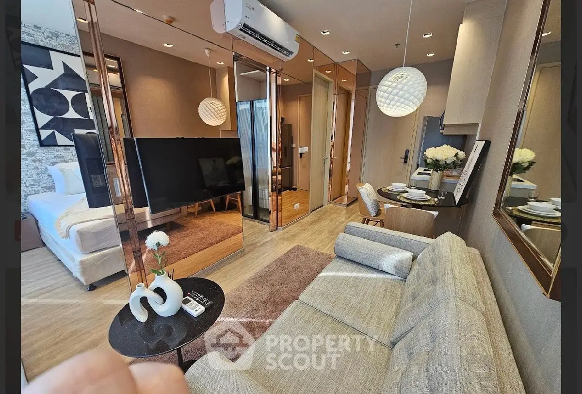 Modern living room with stylish decor and open layout, featuring a cozy sofa and elegant dining area.