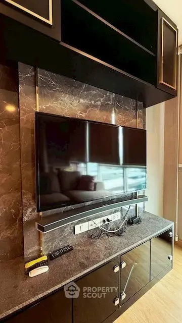 Modern living room with sleek TV setup and marble accents