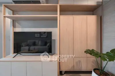 Modern living room with sleek wooden TV cabinet and stylish decor