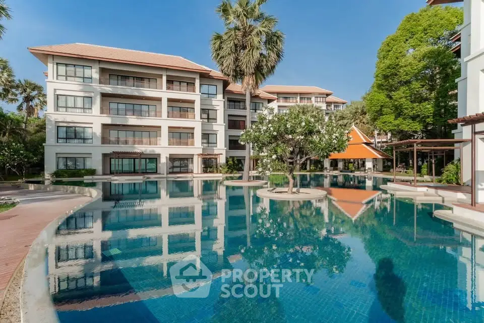 Luxurious residential complex with stunning pool and lush greenery