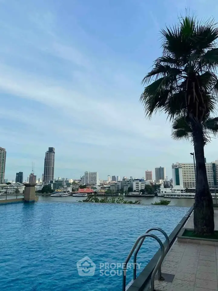 Stunning rooftop pool with panoramic city skyline view and palm tree, perfect for urban relaxation.