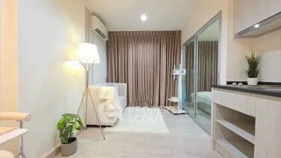 Modern living room with cozy sofa, floor lamp, and elegant curtains