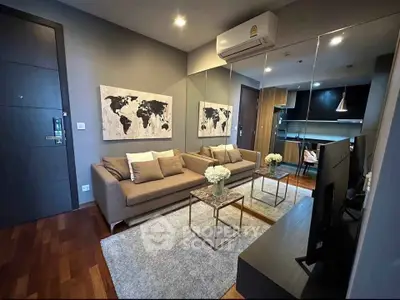 Modern living room with stylish decor and open kitchen layout in a cozy apartment.