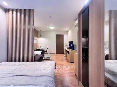 Modern studio apartment with stylish wooden accents and cozy living area.