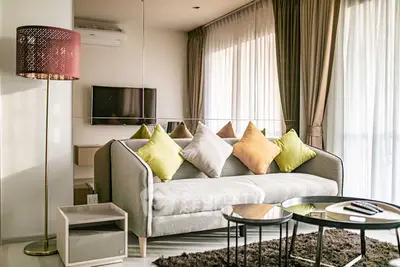 Modern living room with stylish sofa, colorful cushions, and elegant decor