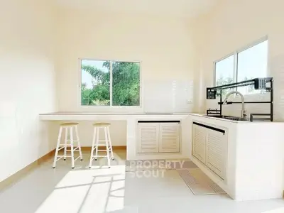 Bright modern kitchen with large windows and minimalist design