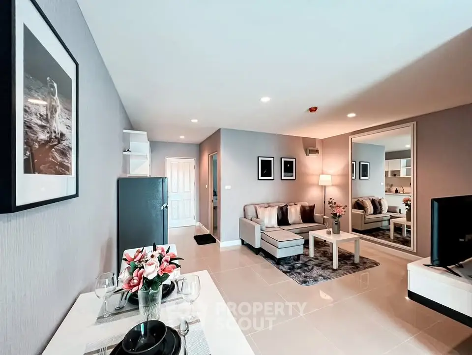 Modern living room with stylish decor and open layout, featuring a cozy seating area and elegant dining space.