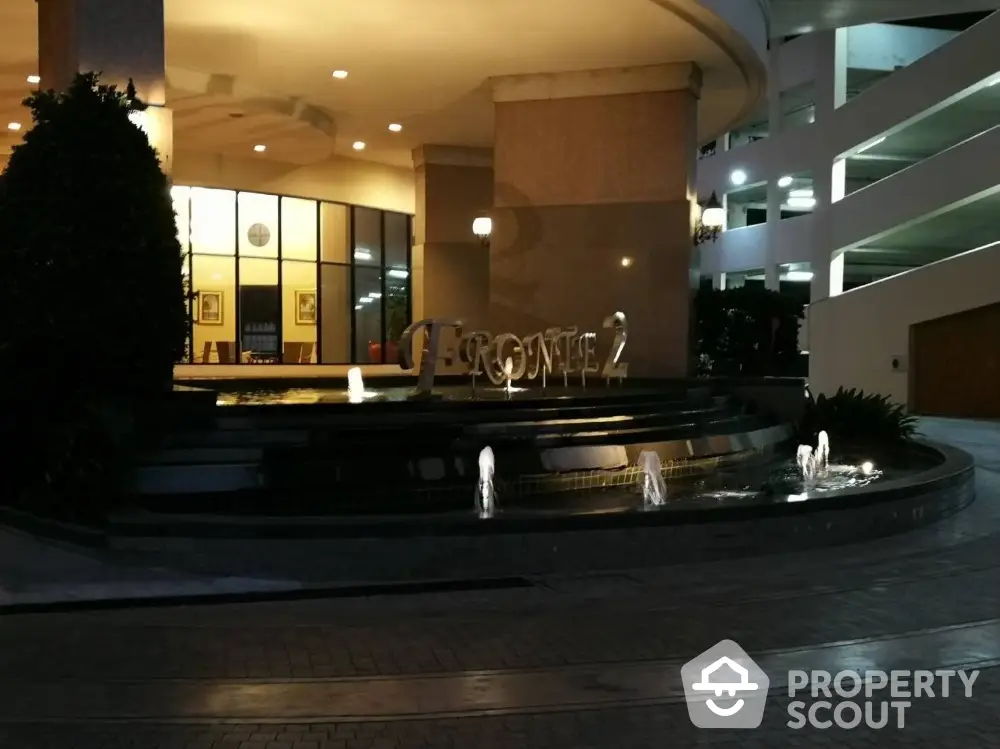 Elegant entrance with modern water feature and ambient lighting at luxury property