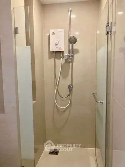 Modern bathroom shower with glass enclosure and electric water heater