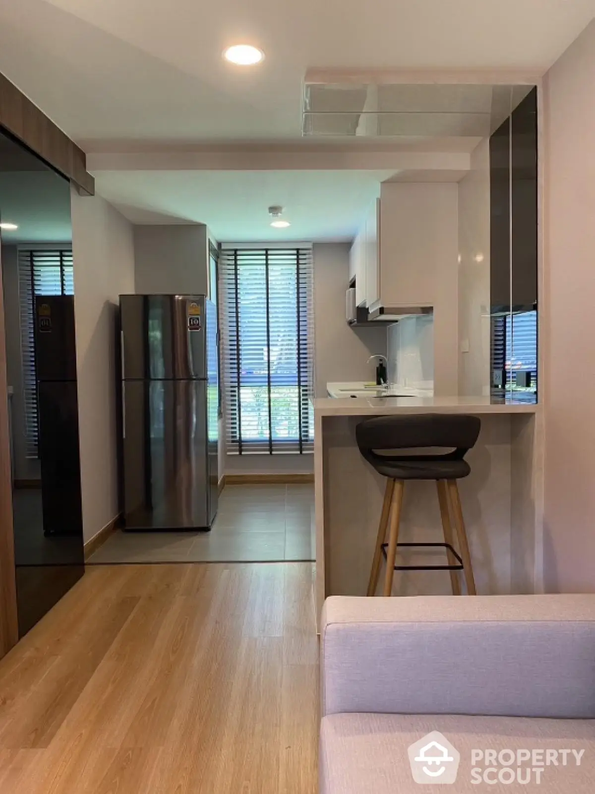 Modern open-layout kitchen with sleek appliances and breakfast bar