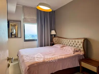 Cozy bedroom with elegant tufted headboard and city view window.