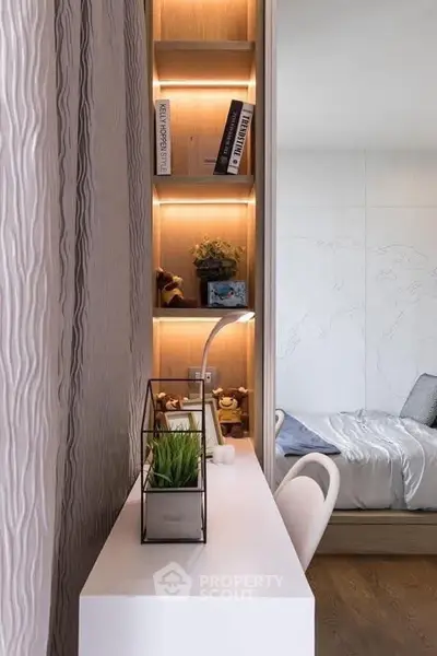 Modern study nook with sleek desk and built-in shelving in stylish apartment.