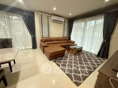 Spacious living room with modern furniture and large windows for natural light.