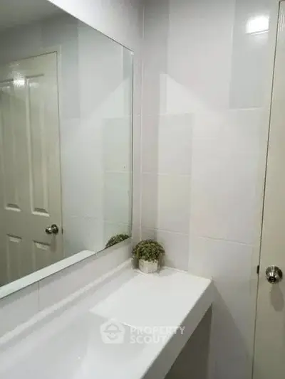 Modern bathroom with sleek white tiles and minimalist decor
