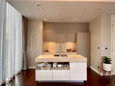 Modern kitchen with sleek design and open layout, featuring a central island and elegant lighting.