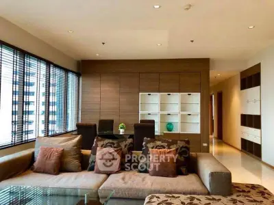 Spacious modern living room with elegant decor and large windows offering city views.