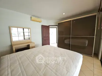 Spacious bedroom with modern wardrobe and air conditioning, perfect for comfort and style.
