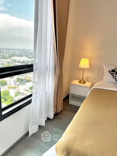 Cozy bedroom with city view, elegant decor, and natural light