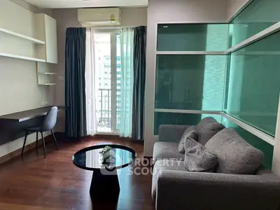 Modern living room with sleek furniture and large window offering city view