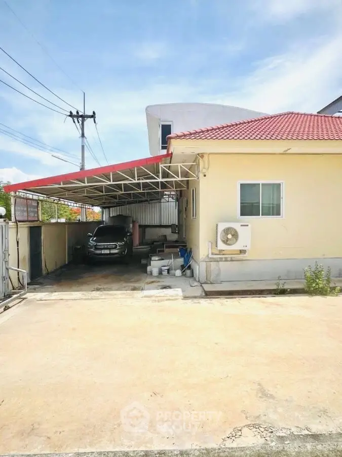 Charming suburban home with carport and red roof, ideal for family living.