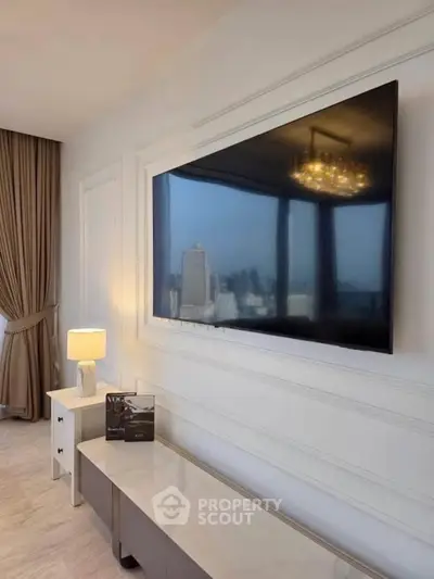 Luxurious living room with modern TV setup and city view, elegant decor and ambient lighting.
