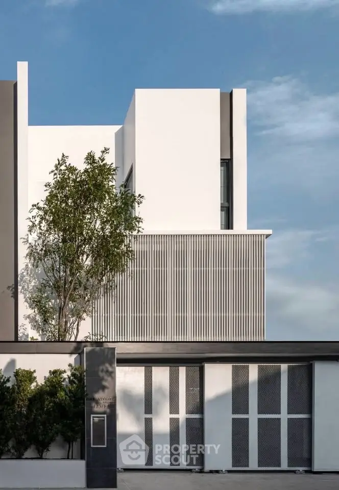 Modern architectural facade with sleek lines and lush greenery, showcasing contemporary design elegance.