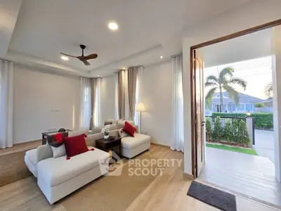Spacious living room with modern decor and open view to lush garden, perfect for relaxation and entertaining.