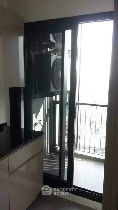 Modern kitchen with balcony access and city view