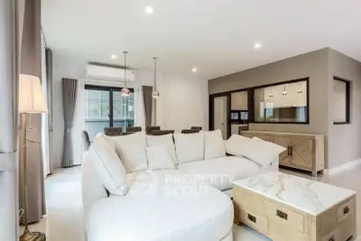 Spacious modern living room with elegant decor and large windows