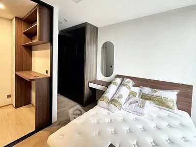 Modern bedroom with stylish wooden shelves and cozy bed in a chic apartment.