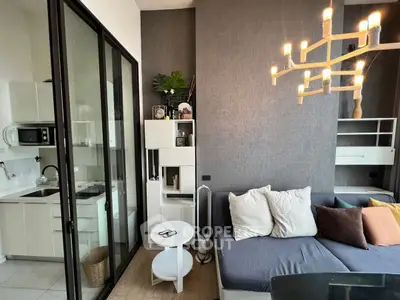 Modern living room with cozy sofa and stylish kitchen area