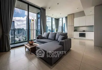 Luxurious modern living room with stunning city view and sleek furnishings in high-rise apartment.