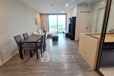 Spacious modern living room with dining area and large windows offering stunning views.