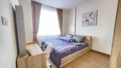 Cozy bedroom with wooden flooring and elegant decor