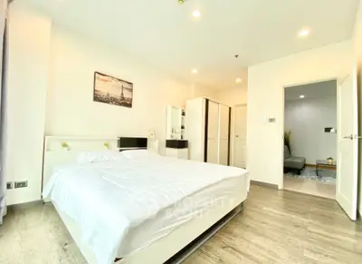 Spacious modern bedroom with elegant decor and natural light
