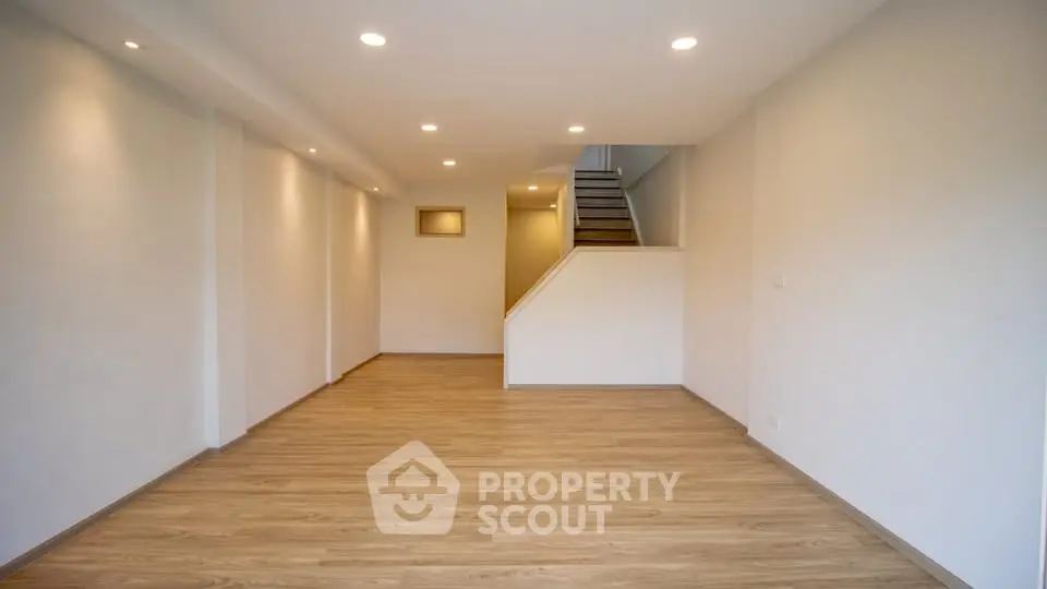 Spacious modern living room with wooden flooring and recessed lighting