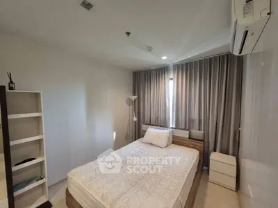 Cozy bedroom with modern furnishings and ample natural light