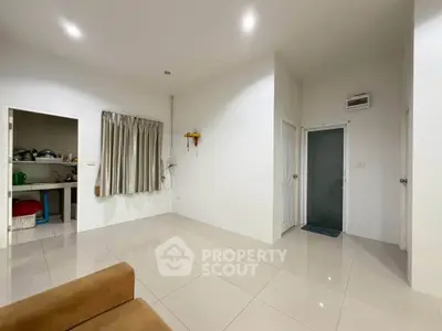 Spacious modern living area with tiled flooring and neutral decor